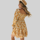 Back view of Anna Boho Paisley Mini Dress in yellow, highlighting the back details of the dress