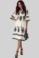 Side view of the Anna Embroidered Boho Midi Dress in white, displaying the dress’s fit and style