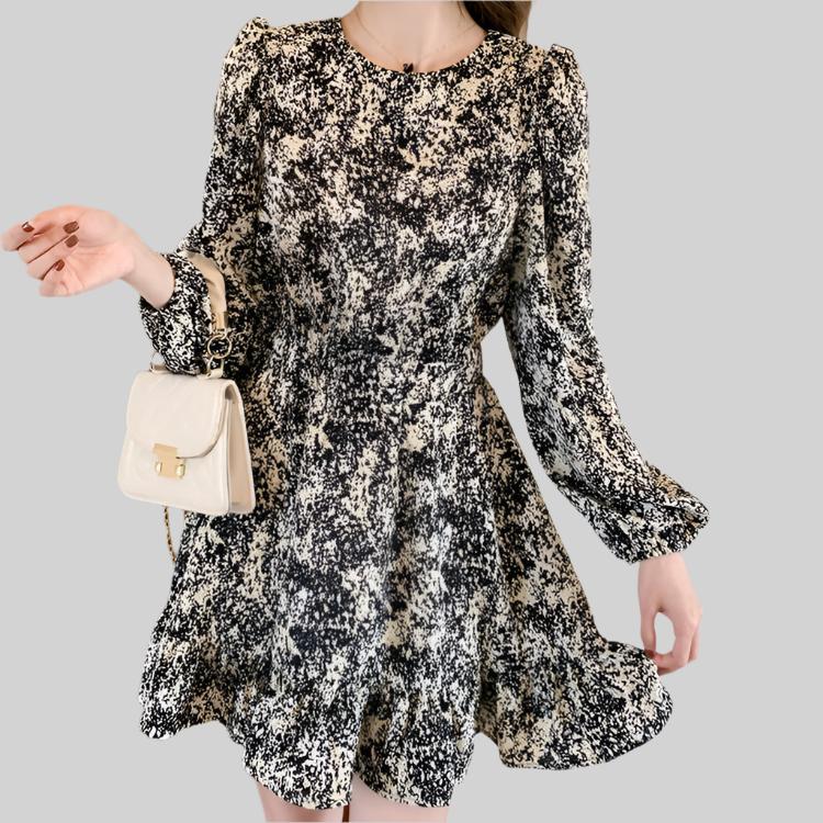 Close-up of the floral pattern on the Anna Floral Long-Sleeve Mini Dress in black