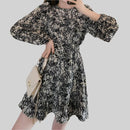 Lifestyle shot of a model wearing the Anna Floral Long-Sleeve Mini Dress in black, styled for a chic occasion