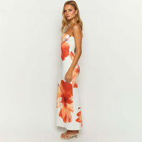 Lifestyle image of a model wearing the Anna Floral Strapless Maxi Dress, styled for a summer event