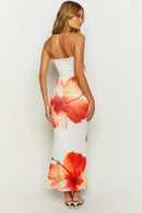 Lifestyle image of a model wearing the Anna Floral Strapless Maxi Dress, styled for a summer event